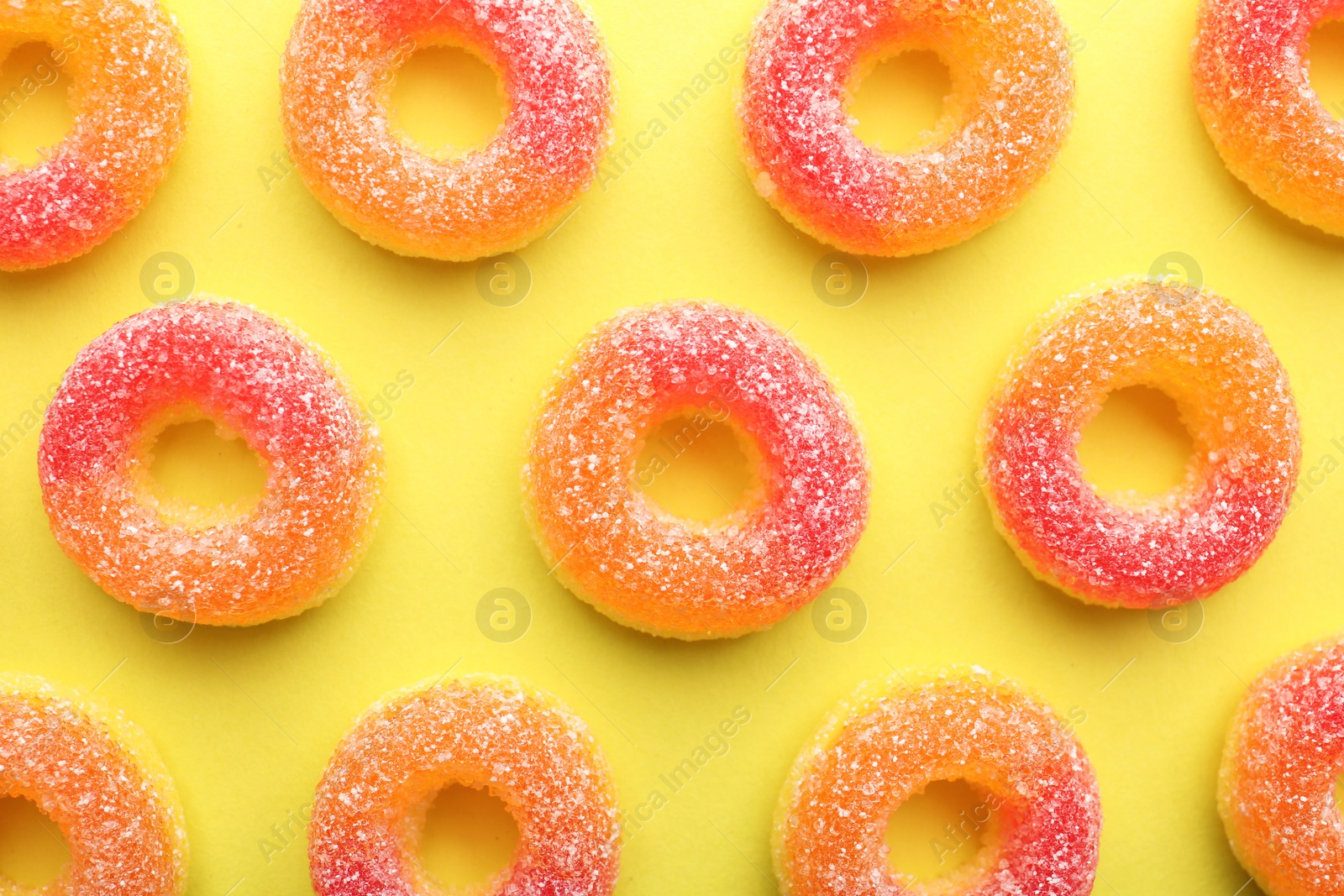 Photo of Tasty jelly candies on color background, flat lay