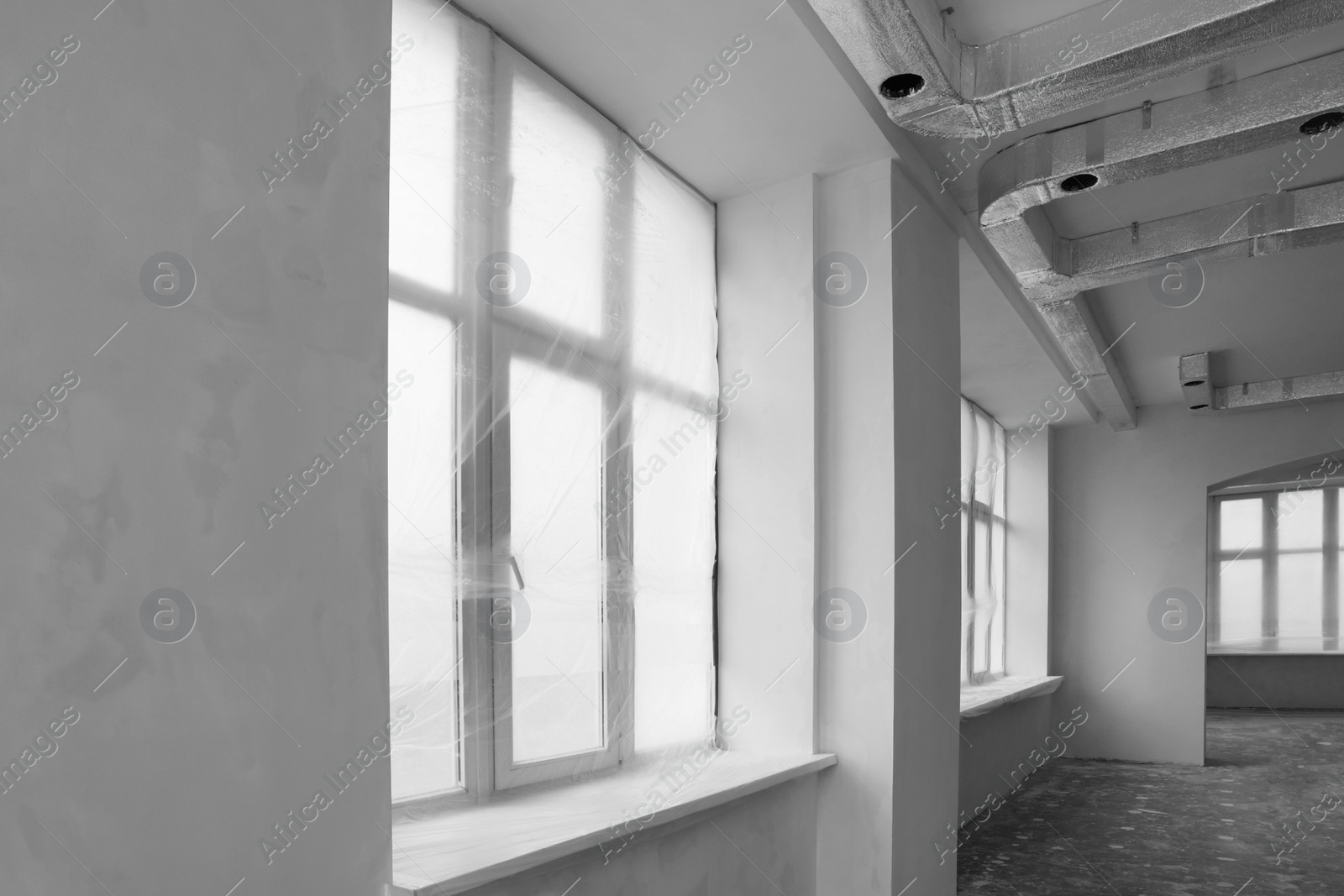 Photo of Windows covered with plastic film in spacious room
