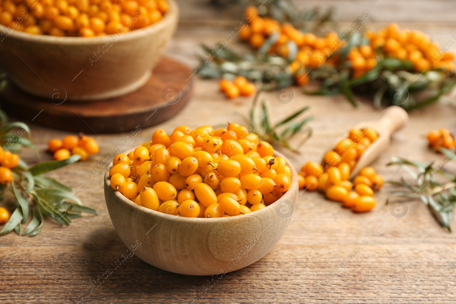 Photo of Ripe sea buckthorn berries on wooden table