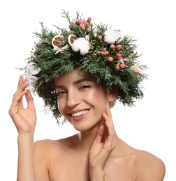 Happy young woman wearing wreath on white background