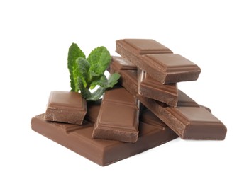 Tasty chocolate pieces and mint on white background