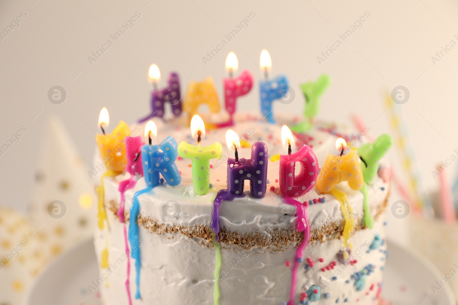 Photo of Tasty Birthday cake with burning candles on table, closeup