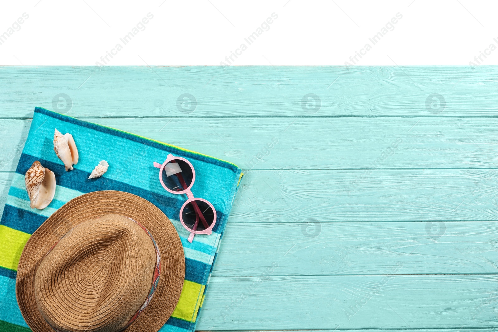 Photo of Flat lay composition with beach accessories on wooden background. Space for text