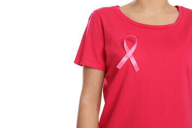 Woman with pink ribbon on white background, closeup. Breast cancer awareness