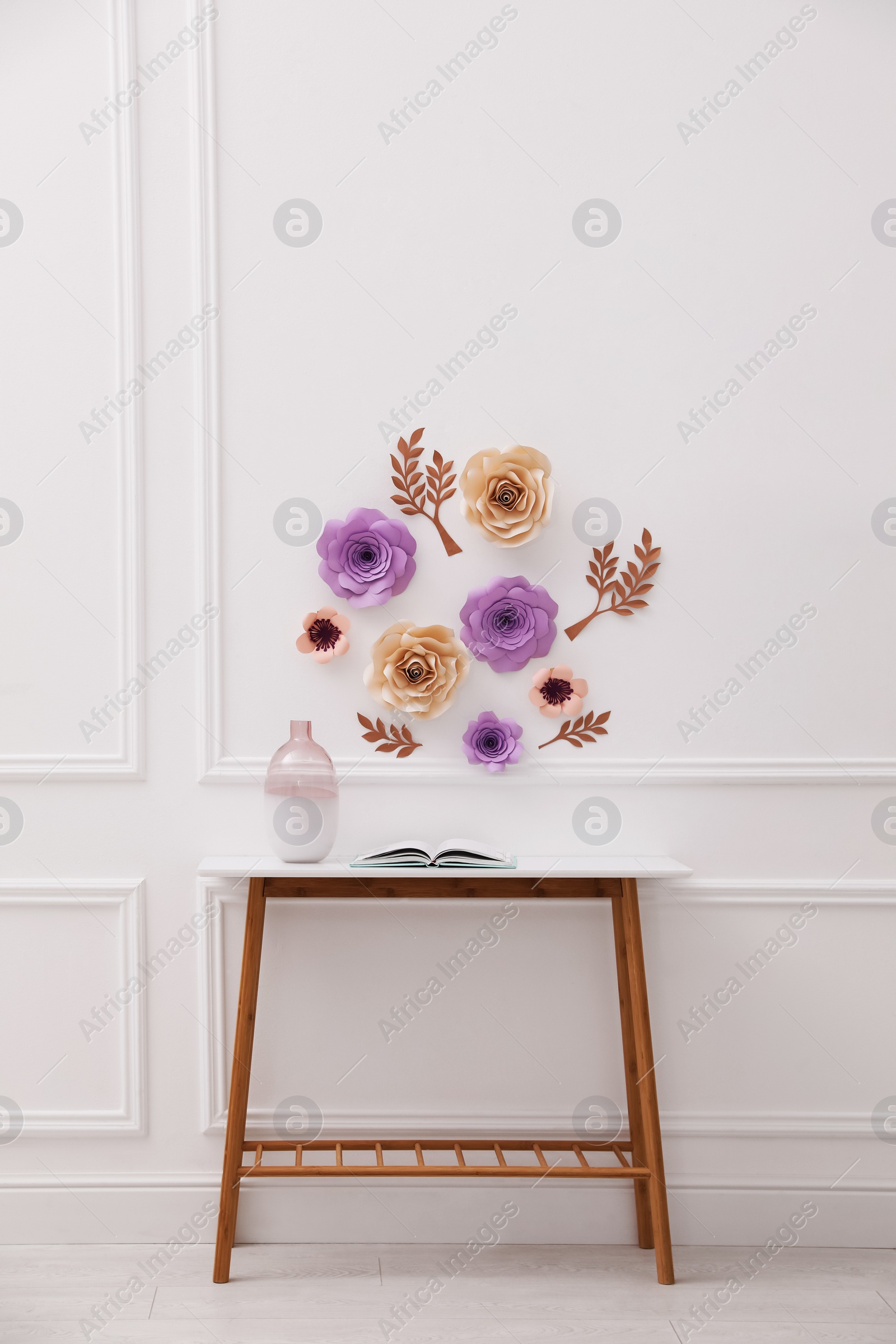 Photo of Stylish room interior with floral decor and table