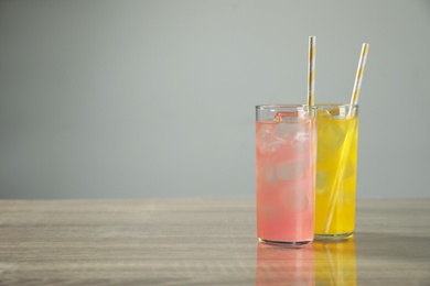 Photo of Delicious refreshing drinks on grey table. Space for text