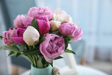 Photo of Bouquet of beautiful peonies in room, space for text