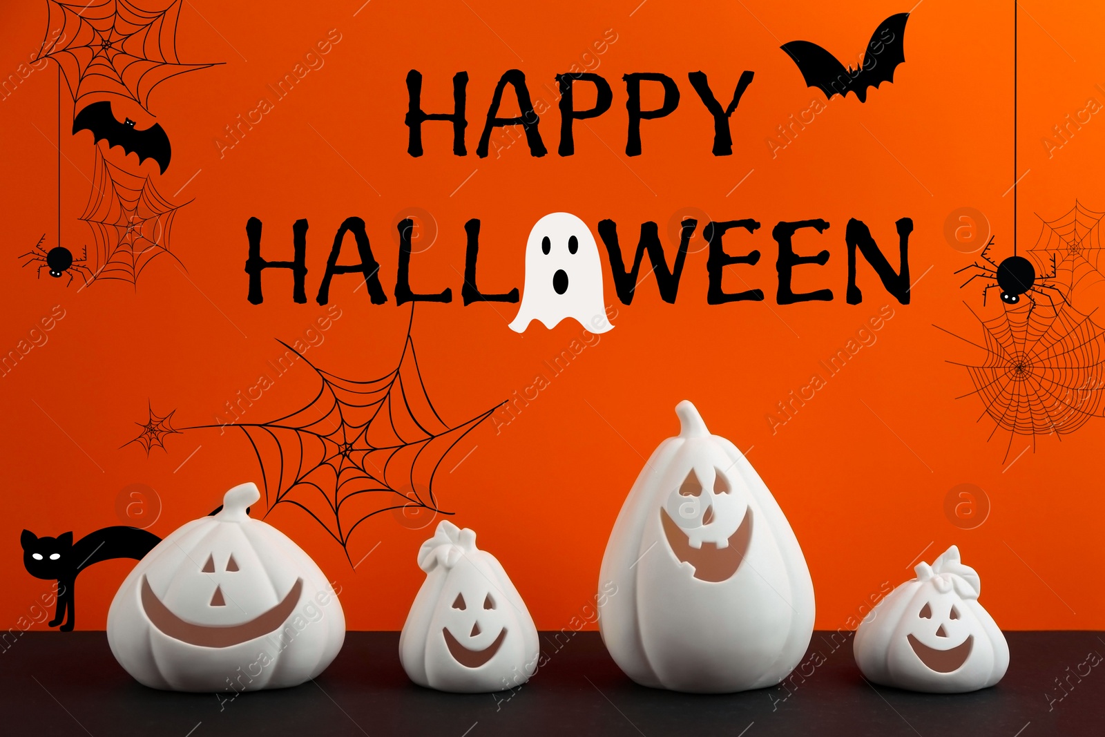 Image of Happy Halloween greeting card design. White pumpkin shaped candle holders on black table against orange background with illustrations