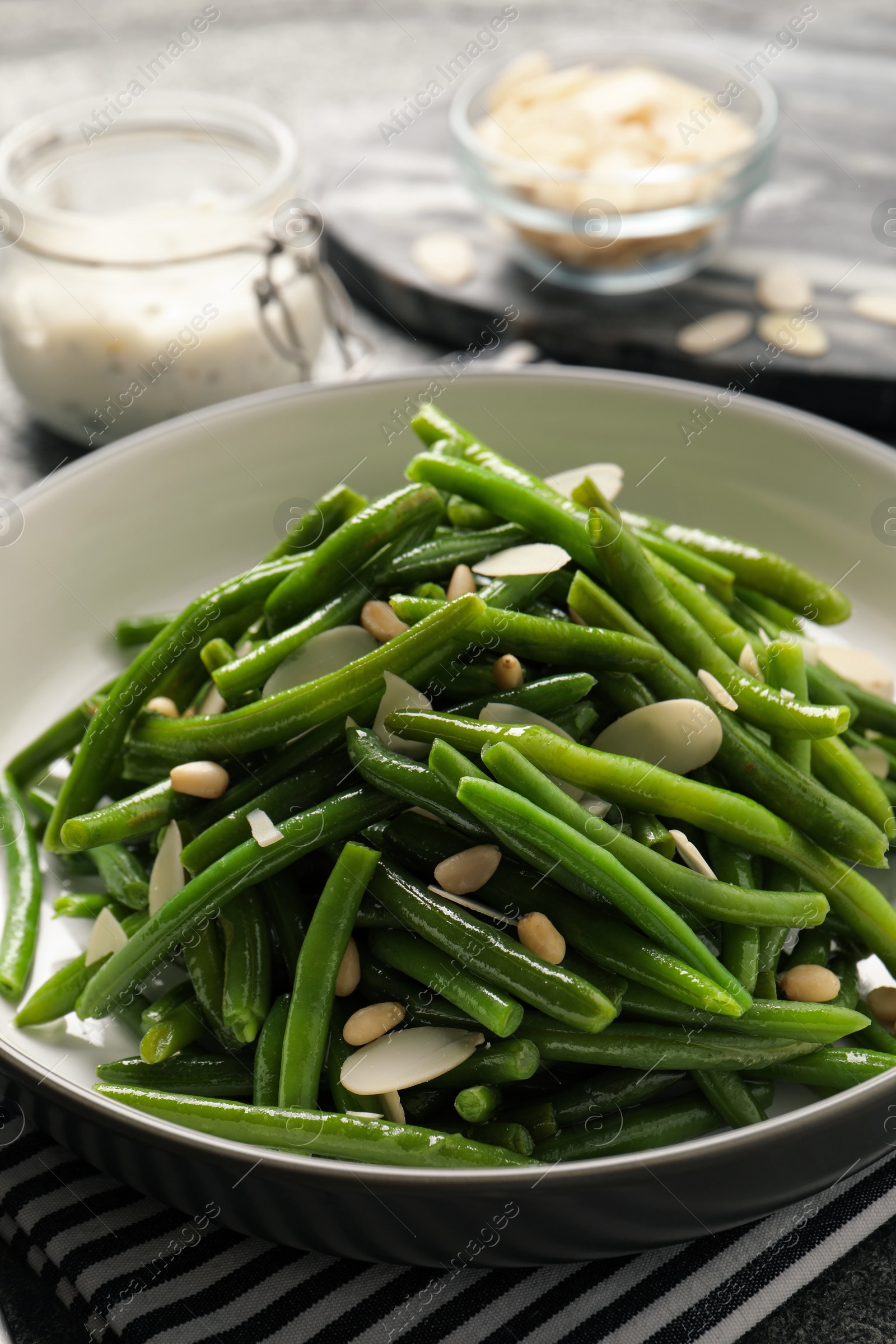 Photo of Bowl of tasty salad with green beans on table