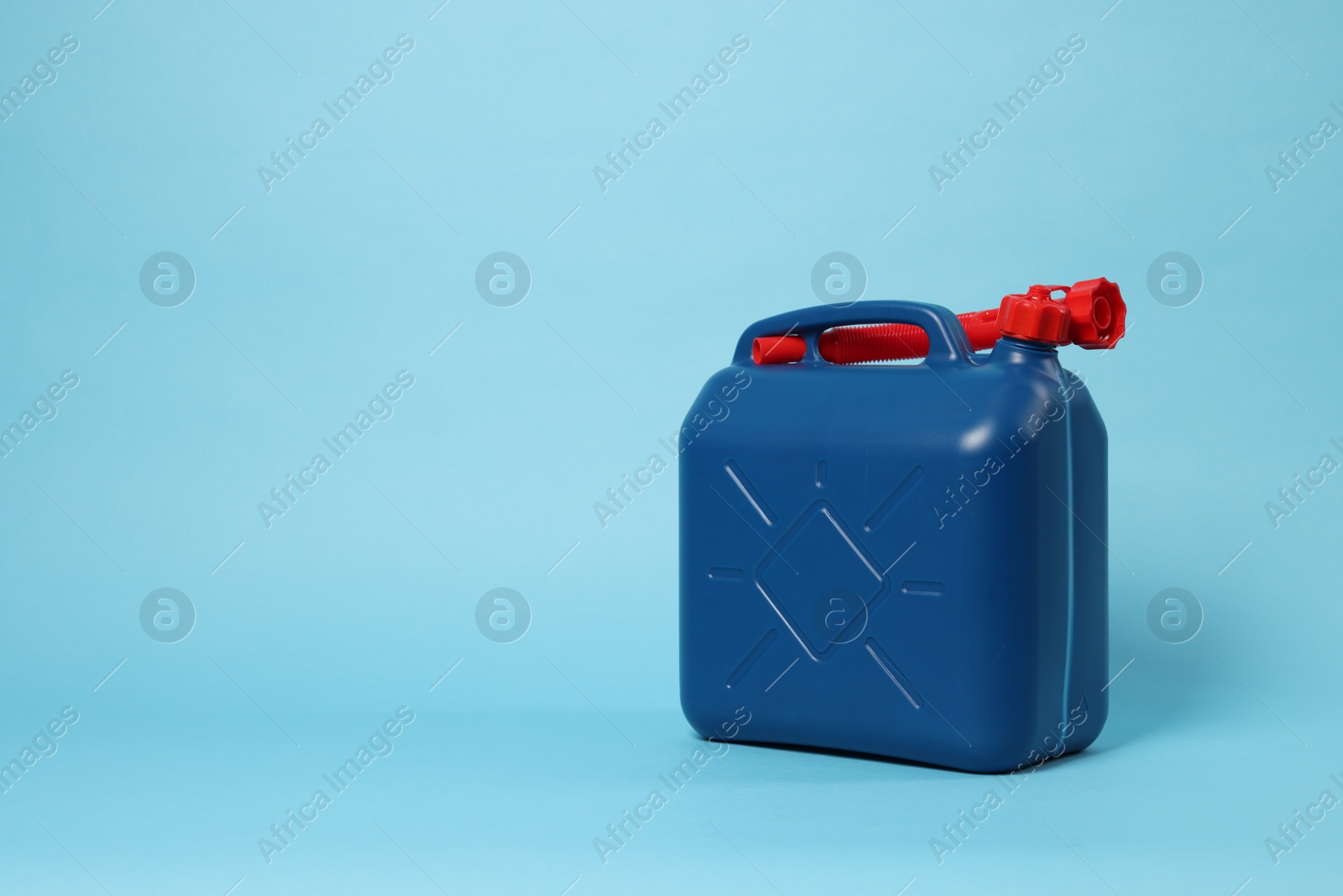 Photo of New plastic canister on light blue background. Space for text