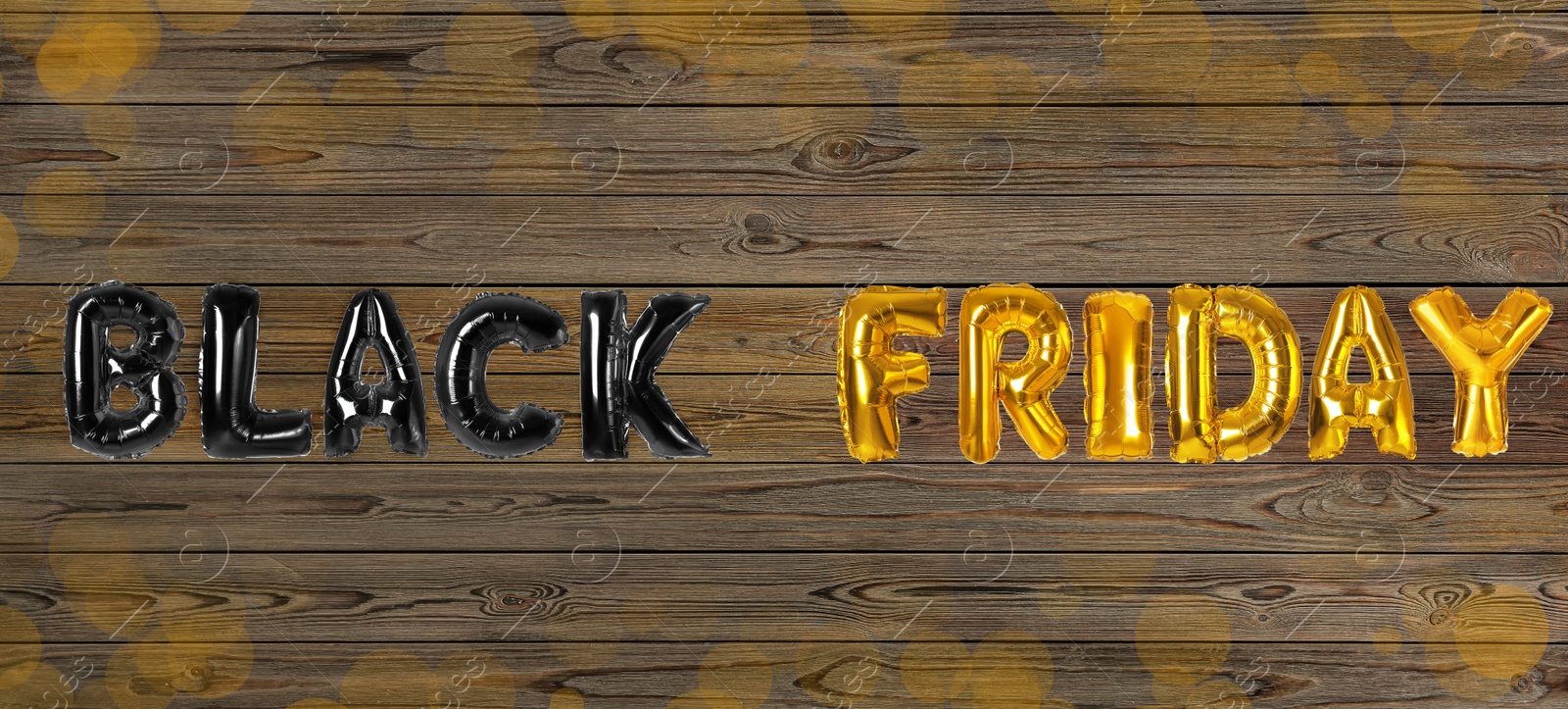 Image of Phrase BLACK FRIDAY made of foil balloon letters on wooden background. Banner design