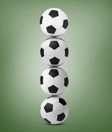 Image of Stack of soccer balls on pale green background