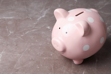 Photo of Pink piggy bank on table. Money saving