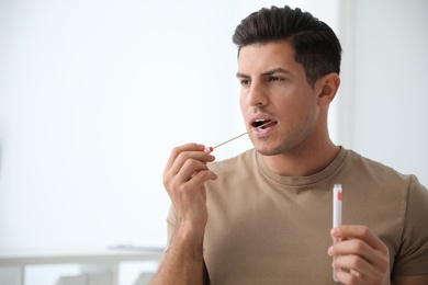 Photo of Man taking sample for DNA test indoors