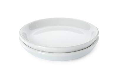 Photo of New ceramic plates on white background. Tableware