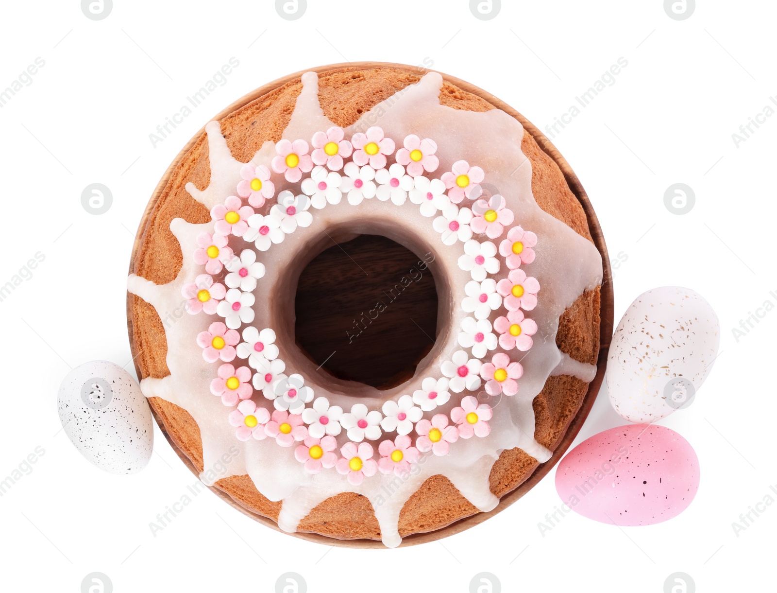 Photo of Festively decorated Easter cake and painted eggs on white background, top view