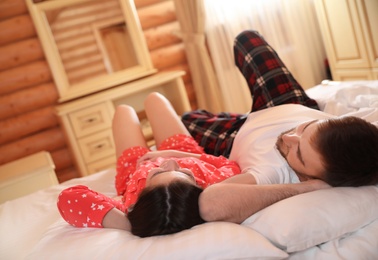 Photo of Couple lying in bed at home. Lazy morning