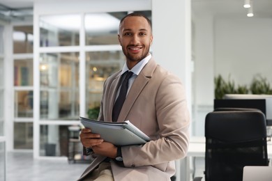 Photo of Happy man with folders in office. Lawyer, businessman, accountant or manager