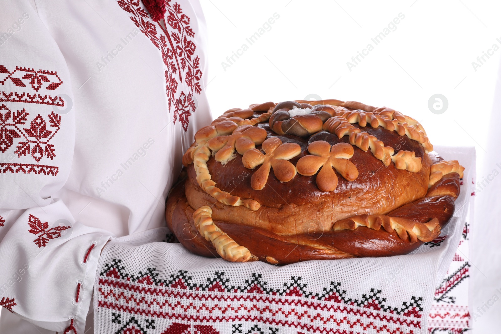 Photo of Woman with korovai on white background, closeup. Ukrainian bread and salt welcoming tradition