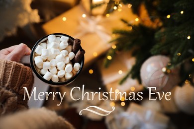 Image of Merry Christmas Eve, postcard design. Woman with cup of tasty cocoa indoors, top view 