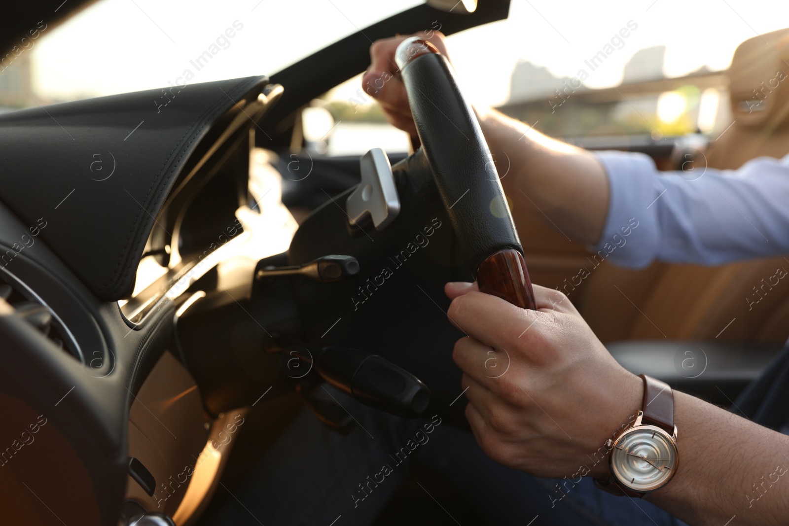 Photo of Stylish man driving luxury convertible car, closeup