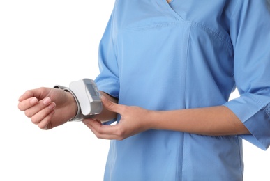 Photo of Female doctor using blood pressure monitor on white background, closeup. Medical object
