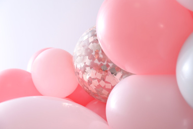 Photo of Beautiful colorful balloons on light background, closeup