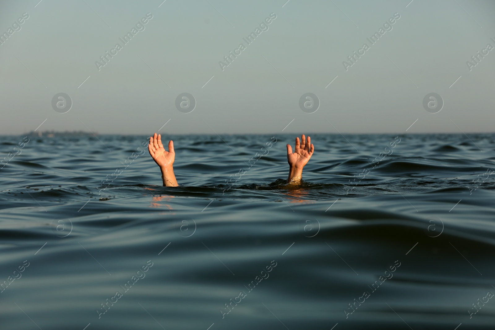 Photo of Drowning man reaching for help in sea