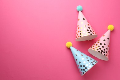 Photo of Beautiful party hats on pink background, top view. Space for text
