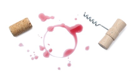 Photo of Red wine ring with drops, bung and corkscrew on white background, top view