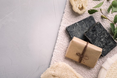 Photo of Flat lay composition with natural tar soap on grey table. Space for text