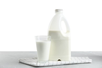 Photo of Gallon bottle and glass of milk on light grey table