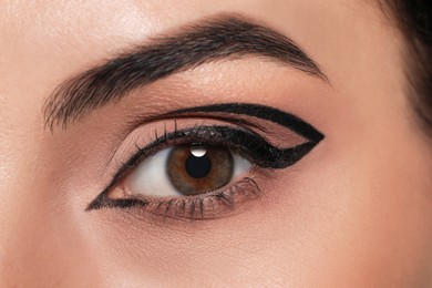 Photo of Beautiful woman with black eyeliner, closeup view