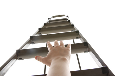 Photo of Woman climbing up stepladder on white background, low angle view