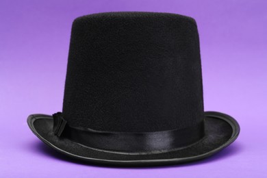 Photo of One magician top hat on violet background