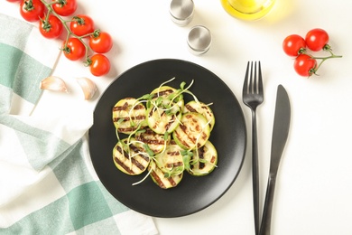 Photo of Flat lay composition with delicious grilled zucchini slices on white table, flat lay