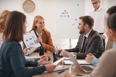 Photo of Businesspeople having meeting in office. Management consulting