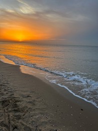 Photo of Beautiful view of sandy beach at sunrise