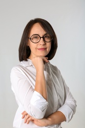 Photo of Portrait of mature businesswoman on light grey background