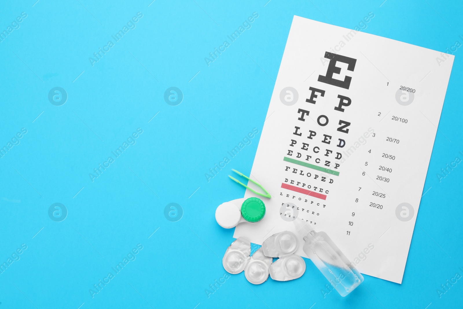 Photo of Flat lay composition with contact lenses on turquoise background, space for text