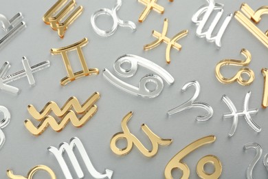 Photo of Zodiac signs on grey background, flat lay