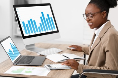 Photo of Professional accountant working at wooden desk in office