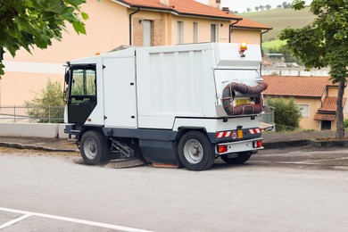 Photo of Modern sweeping car on road in city