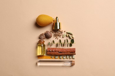 Photo of Bottle of luxury perfume and different ingredients on beige background, flat lay