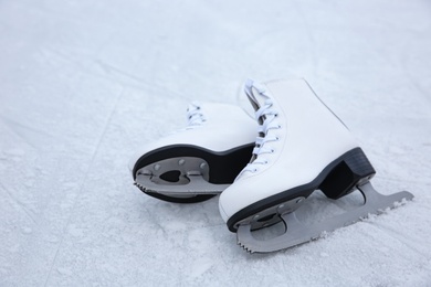 Photo of Pair of figure skates on ice. Winter outdoors activities