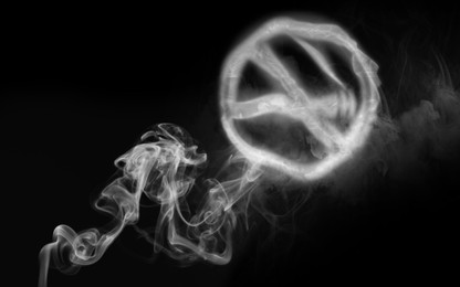 Image of No Smoking. Round sign with crossed cigarette of smoke on black background