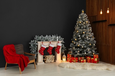 Photo of Stylish Christmas interior with decorated fir tree and fireplace