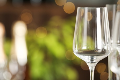 Photo of Empty glass on blurred background, closeup. Space for text