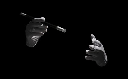 Photo of Magician with magic wand on black background, closeup