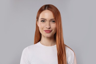 Photo of Portrait of beautiful young woman on light gray background